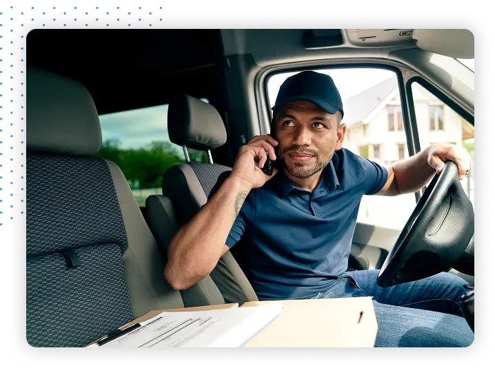 Driver sitting in vehicle on phone